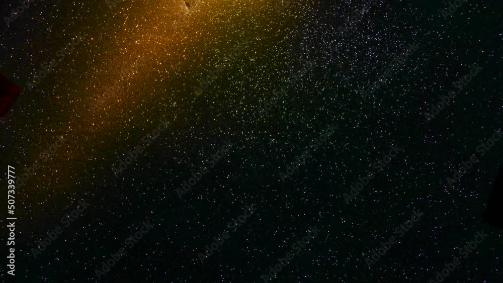 Multi-colored beams of light blink on a dark background. Multi-colored beams of light blink on a dark background.