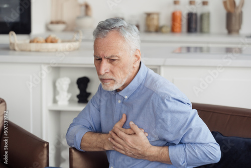 Wallpaper Mural Senior man feeling heart pain, holding hands on chest Torontodigital.ca