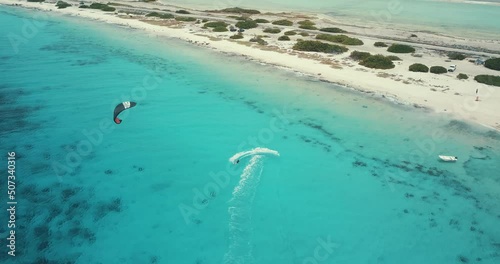 Kitesurfing in Bonaire in a wonderful blue colored water. 4k drone footage