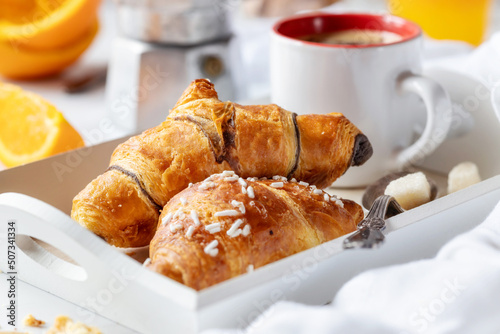 Breakfast concept with croissants, coffee and orange juice photo