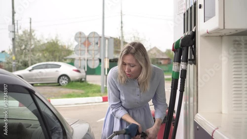 concept of rising gasoline prices. A man is dissatisfied with the high prices at a gas station