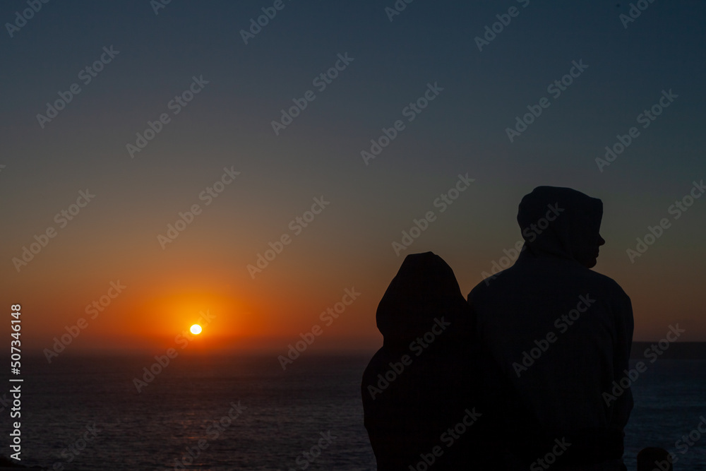 a couple in love enjoy the sunset in the Portuguese fortress of Sagres