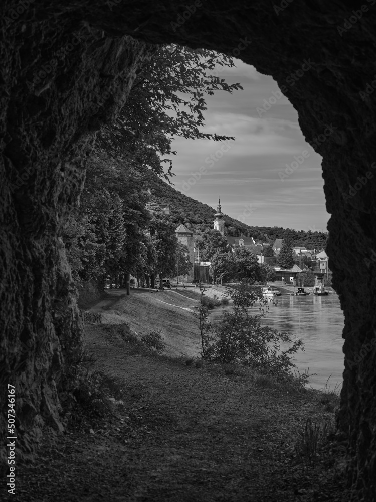 View of the city of Hainburg from a rock tunnel in black and white, Austria View of the city of Hainburg from a rock tunnel in black and white, Austria