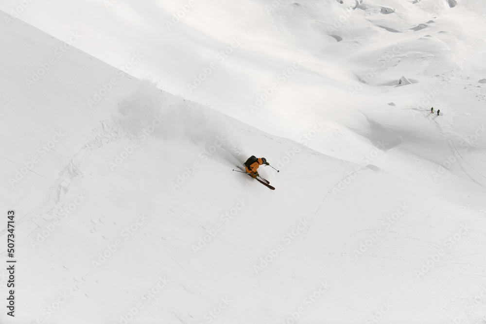Great view on active person moving down on mountain on splitboard at sunny winter day Great view on active person moving down on mountain on splitboard at sunny winter day