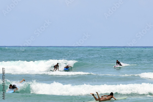 Canvas Print Surfers tackle the waves on Waikiki Beach, Honolulu, Hawaii.