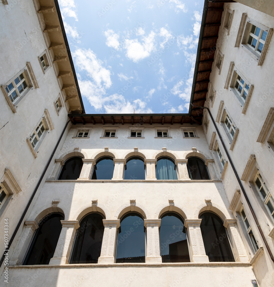 Residential houses in the Italian town of Arco on Lake Garda under blue sky and light clouds