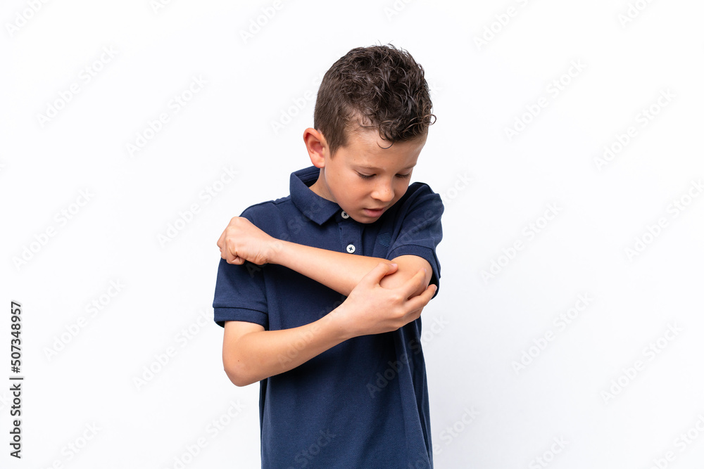 Little caucasian boy isolated on white background with pain in elbow Little caucasian boy isolated on white background with pain in elbow