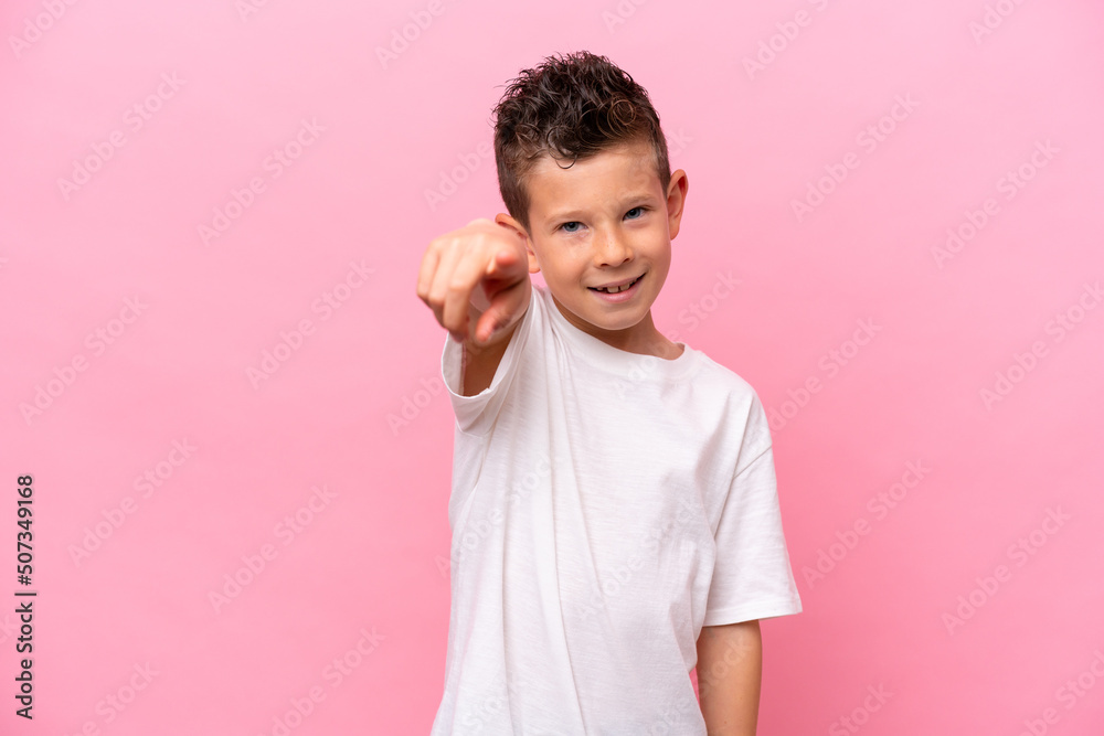 Little caucasian boy isolated on pink background pointing front with happy expression Little caucasian boy isolated on pink background pointing front with happy expression