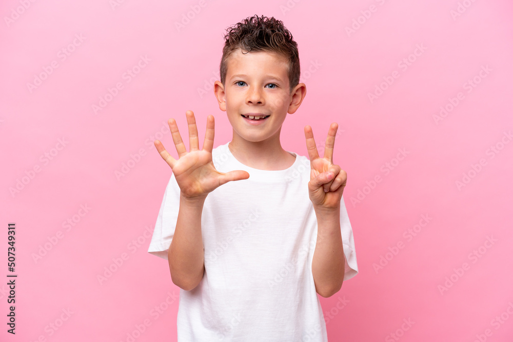 Little caucasian boy isolated on pink background counting seven with fingers Little caucasian boy isolated on pink background counting seven with fingers