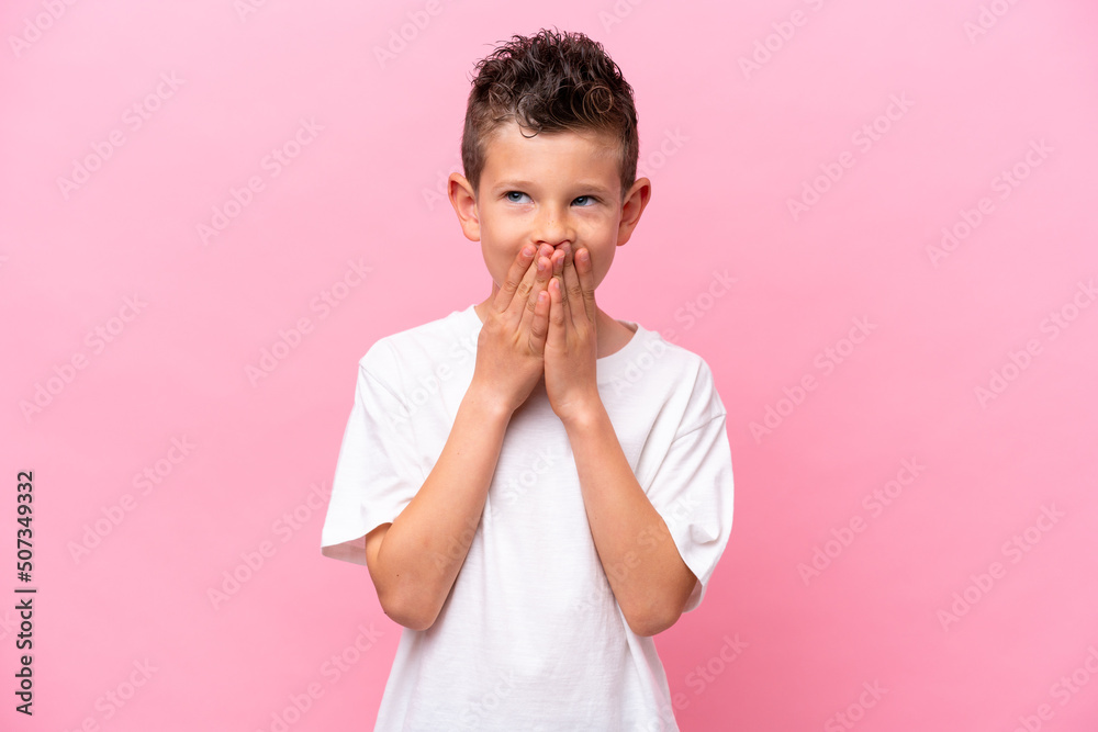 Little caucasian boy isolated on pink background happy and smiling covering mouth with hands Little caucasian boy isolated on pink background happy and smiling covering mouth with hands