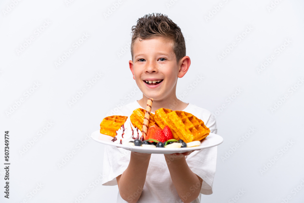 Little caucasian boy holding a waffles isolated on white background Little caucasian boy holding a waffles isolated on white background