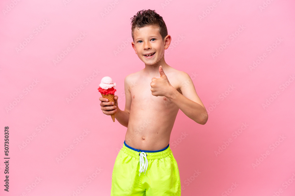 Little caucasian boy eating an ice-cream isolated on pink background with thumbs up because something good has happened Little caucasian boy eating an ice-cream isolated on pink background with thumbs up because something good has happened