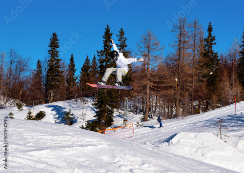 Jumping snowboarder in the ski resort Vogel, Slovenia