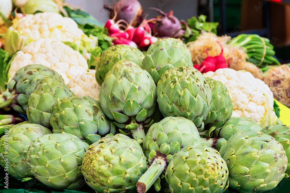 Fresh green artichokes and cauliflower on a market Fresh green artichokes and cauliflower on a market
