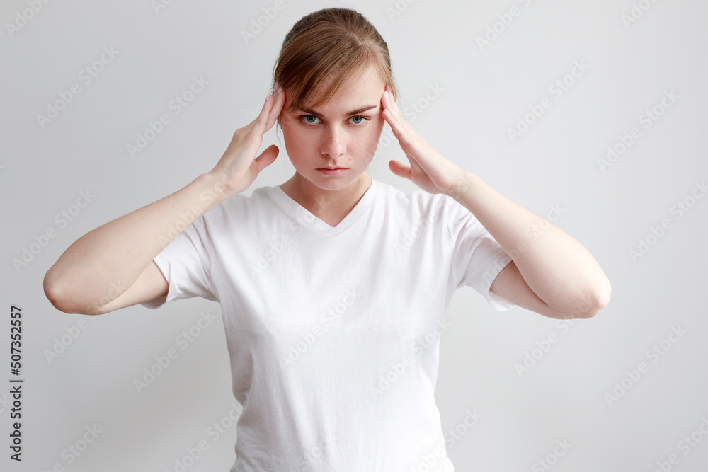 a woman who has a headache on a white background a woman who has a headache on a white background