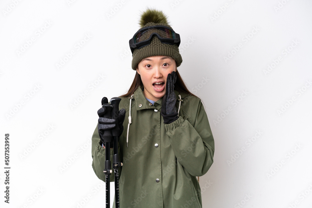 Young Chinese woman wearing winter jacket isolated on white background with surprise and shocked facial expression