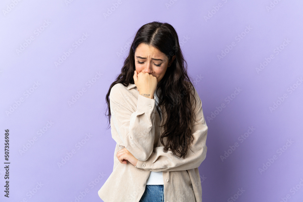 Young caucasian woman isolated on purple background having doubts Young caucasian woman isolated on purple background having doubts