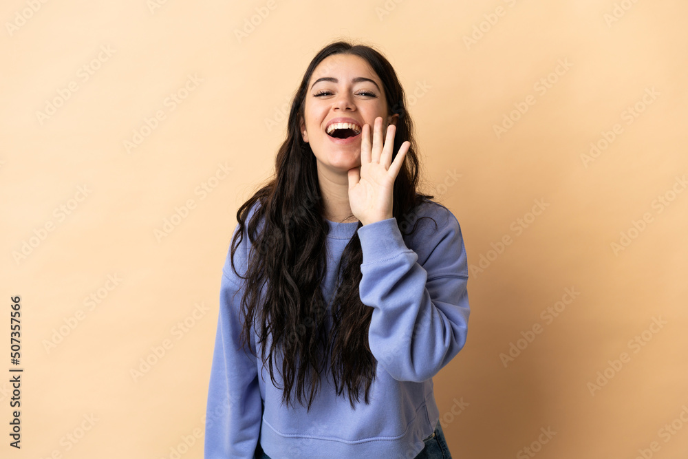 Young caucasian woman over isolated background shouting with mouth wide open Young caucasian woman over isolated background shouting with mouth wide open