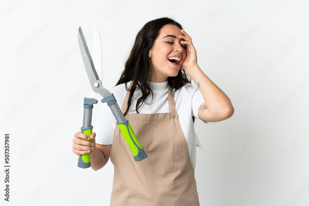 Young caucasian woman holding a plant isolated on white background smiling a lot Young caucasian woman holding a plant isolated on white background smiling a lot