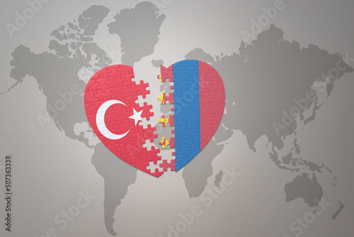 puzzle heart with the national flag of turkey and mongolia on a world map background. Concept.