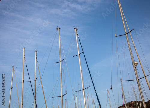Sail masts in the marina. Ship mast with blue sky.