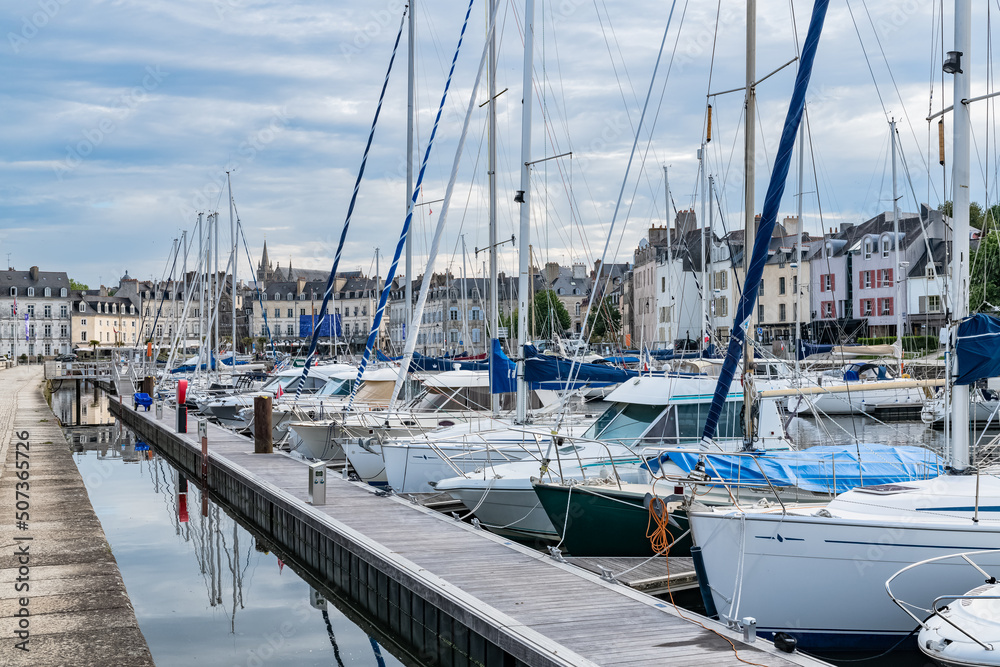 Vannes, beautiful city in Brittany, boats in the harbor, with the cathedral in background 
