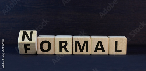 Formal or normal symbol. Turned wooden cubes and changed the concept word formal to normal. Beautiful black table black background. Business formal or normal concept. Copy space.