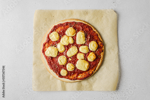 cooking pizza with cheese and tomatoes photo