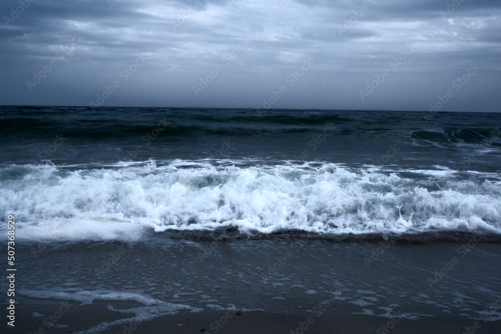 Landscape of blue ocean waves with beautiful clouds.