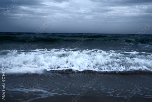 Landscape of blue ocean waves with beautiful clouds.