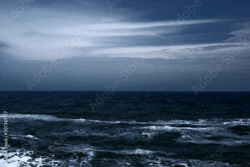 Landscape of blue ocean waves with beautiful clouds.
