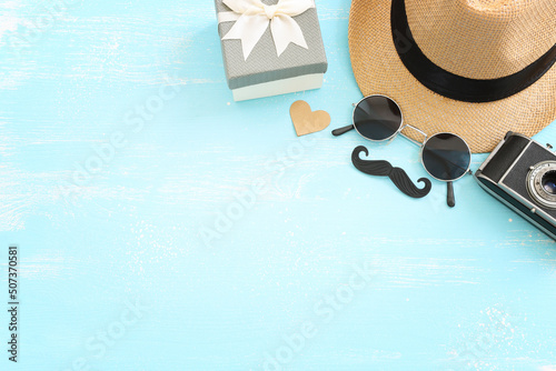 Father's day and travel concept over blue wooden background. top view, flat lay