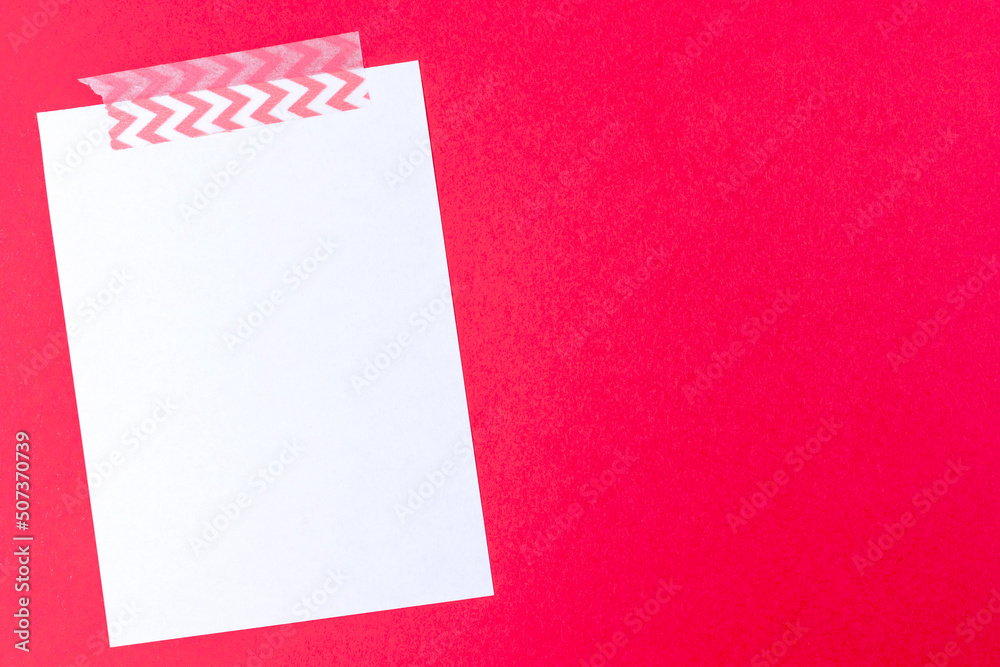 White notebook paper sheet mockup on red background with copy space. Letter template for valentine day, invitation, memo, message White notebook paper sheet mockup on red background with copy space. Letter template for valentine day, invitation, memo, message