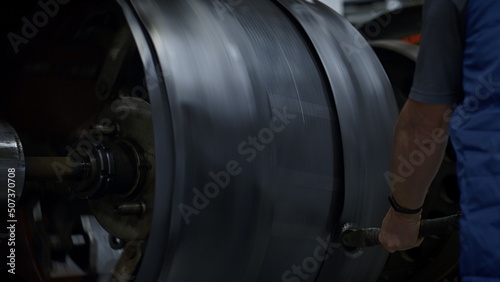 Tyre production factory employee controlling manufacturing process closeup