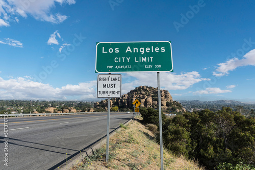 Los Angeles city limit sign on Topanga Canyon Blvd - State Route 27 in Chatsworth, California.  Stoney Point park is in background. photo