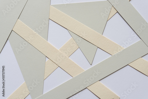 gray and ivory paper shapes on a light background