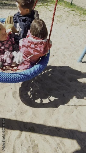 Wallpaper Mural Three children swinging on swings Torontodigital.ca