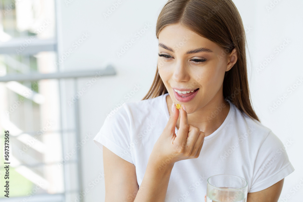 Beautiful Woman Holding Fish Oil Pill In Hand Beautiful Woman Holding Fish Oil Pill In Hand