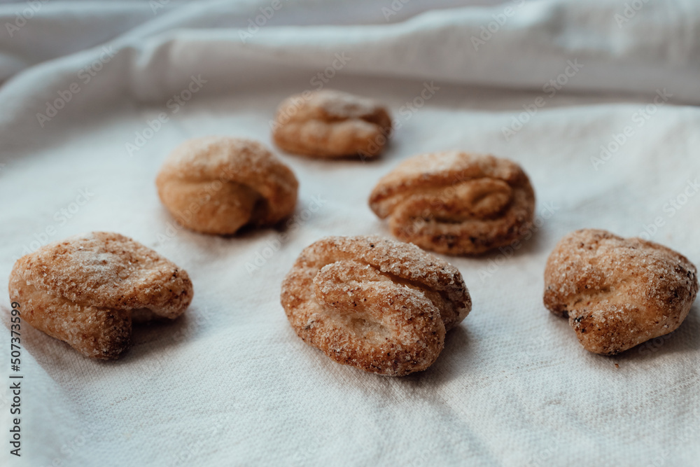 Bakery products. Homemade cookies with sugar on a towel background. Background image, copy space. Bakery products. Homemade cookies with sugar on a towel background. Background image, copy space.