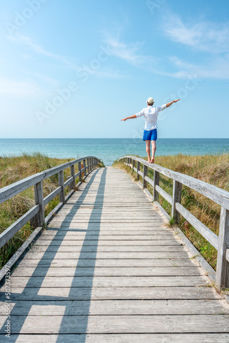 Young man enjoying his freedom near the beach