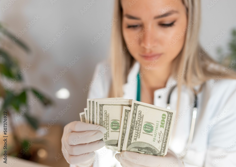 Expensive medicine. Smiling doctor counts money. Concept for medical insurance or corruption in medicine. Expensive medicine. Smiling doctor counts money. Concept for medical insurance or corruption in medicine.