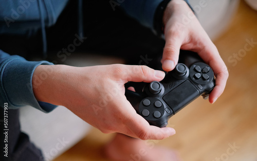 Joystick for game console in the mans hands.The concept of leisure and entertainment
