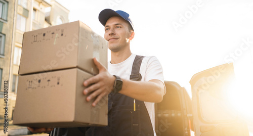 Obraz na plátně The driver in the uniform of the courier company fast delivery of goods to the house