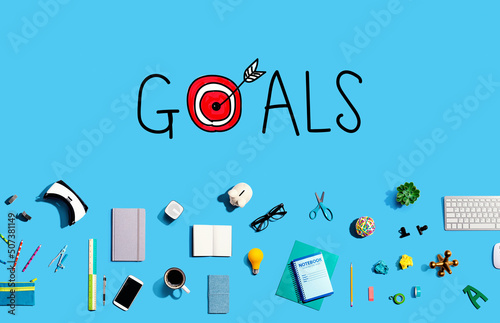 Goal concept with collection of electronic gadgets and office supplies