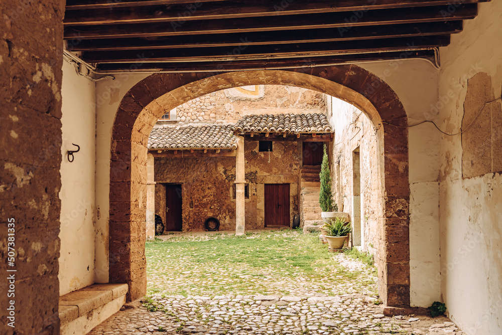 Naklejka premium Old Spanish courtyard. Arch. City of Valldemossa