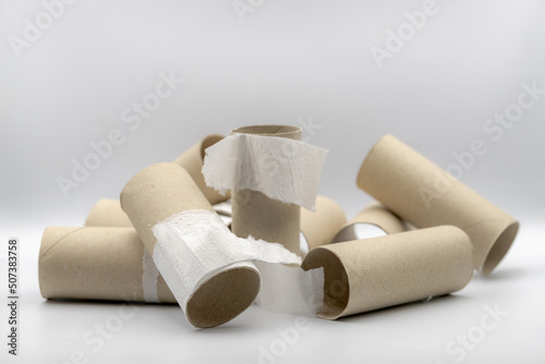 Sanitary and household, Used toilet paper roll lay stacked on white background, Empty brown tissue paper core with free copy space.