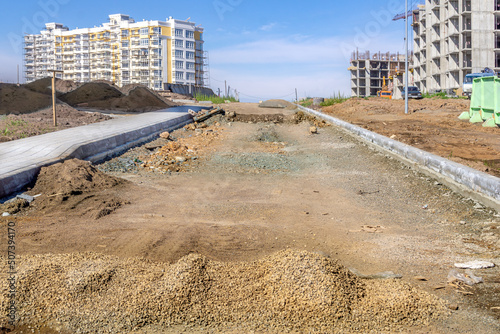 backfilling of the roadbed and arrangement of footpaths in the area under construction photo
