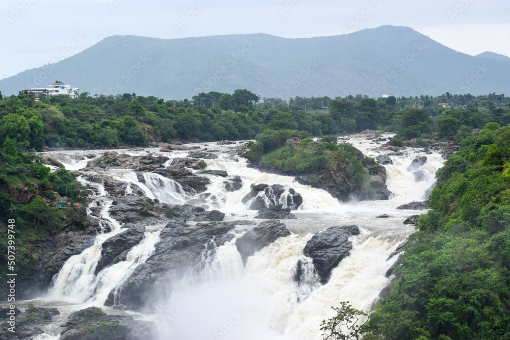High speed waterfall with water colliding with trees and rocks. A Beautiful spectacle to watch High speed waterfall with water colliding with trees and rocks. A Beautiful spectacle to watch