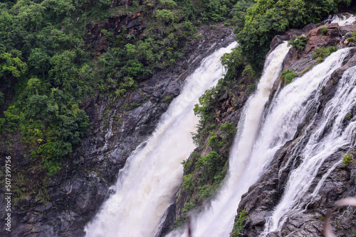 High speed waterfall with water colliding with trees and rocks. A Beautiful spectacle to watch 