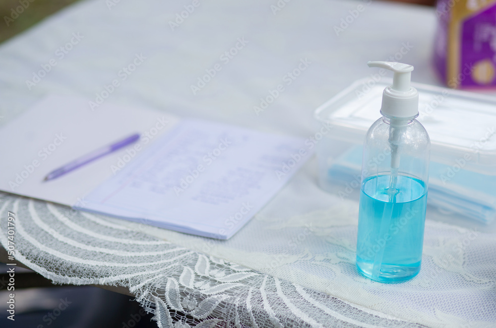 Blue hand sanitizer in a bottle to prevent covid 19 and sign book. Blue hand sanitizer in a bottle to prevent covid 19 and sign book.
